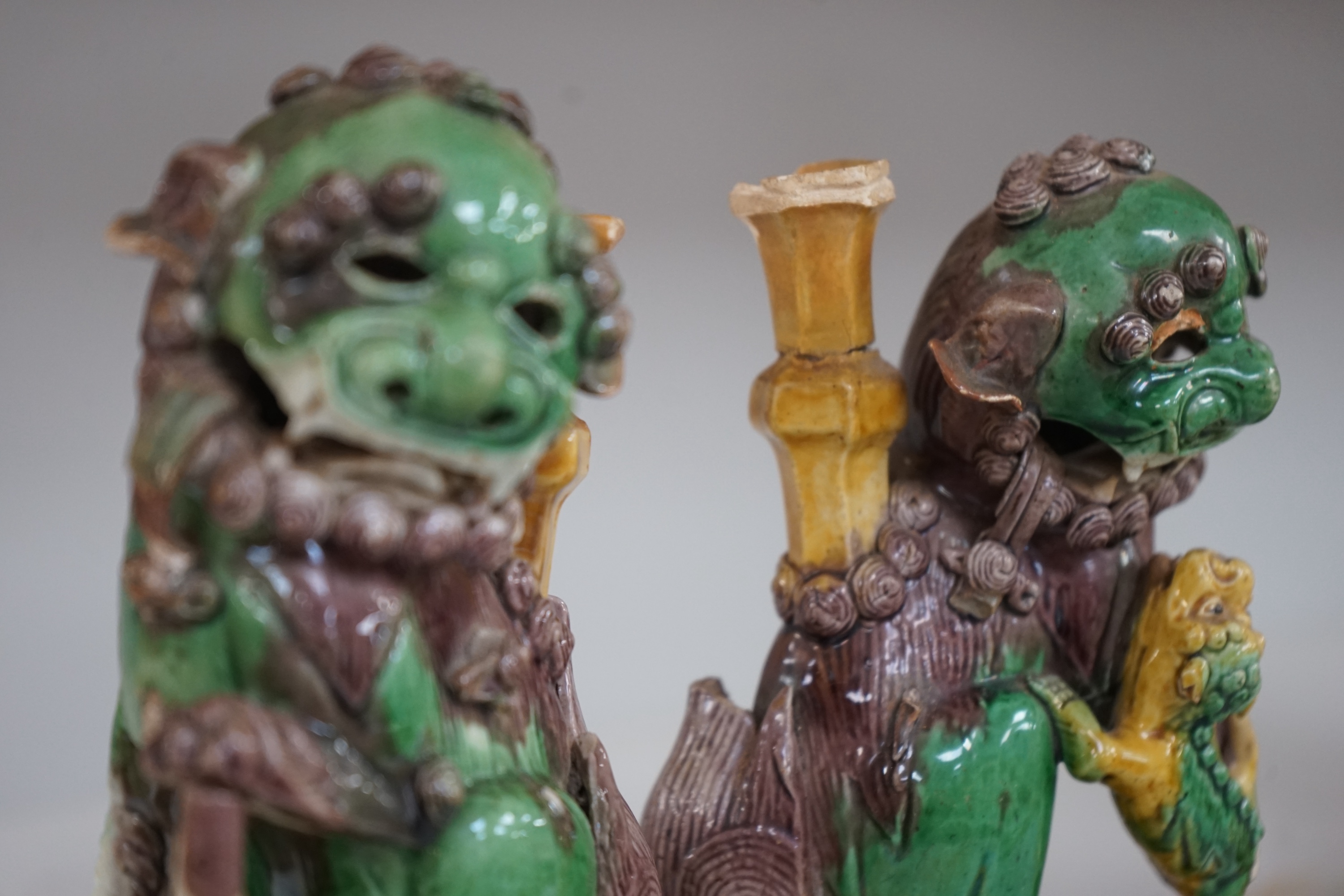 A pair of Chinese Sancai glazed lion joss stick holders, 18th century, 17cm high. Condition - some restoration